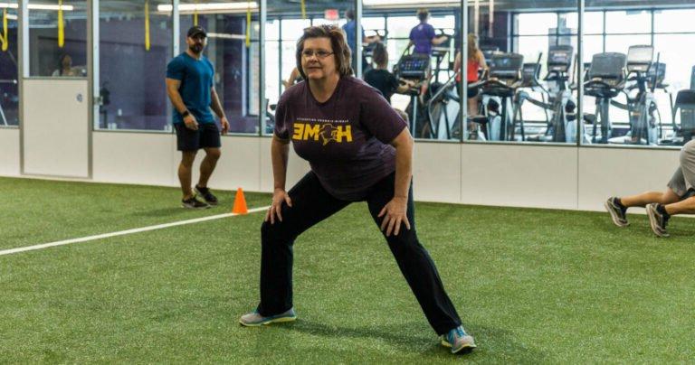 A woman doing group exercise.